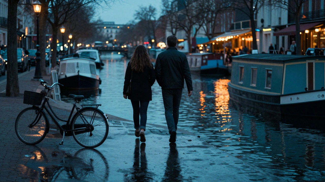 Silhouettes walking along Canal Saint-Martin at dusk, reflections in water.