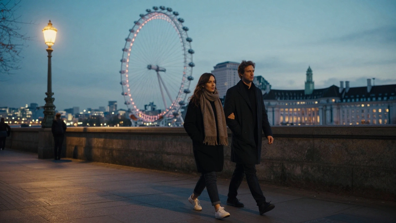 Two people walking side by side along the Thames at twilight, silhouetted against the glowing city.
